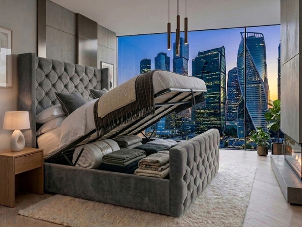 Reina Ottoman Storage Bed in grey velvet with the base lifted, revealing the spacious under-bed storage compartmen