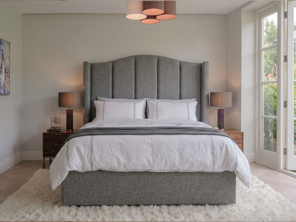 Jimena wingback ottoman storage bed in Steel Atlanta Soft Teddy, front view showing the curved headboard with deep vertical fluted channels