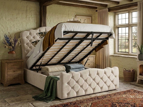 Melibea Ottoman Storage Bed in cream velvet, displayed with the mattress lifted to highlight the expansive, easy-access ottoman storage compartment