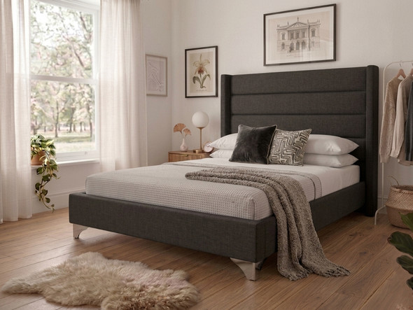 Dark charcoal linen Micaela upholstered bed frame featuring a tall, fluted wingback headboard, showcasing premium West Midlands craftsmanship