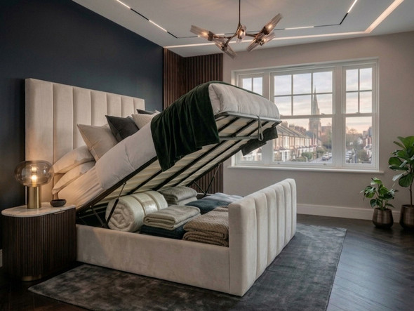 Pale cream velvet Anette ottoman bed with gas-lift base raised, showing deep under-bed storage