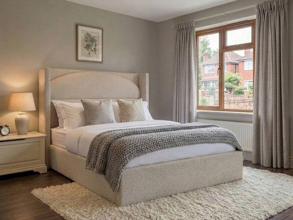 Svea Ottoman Storage Bed Frame upholstered in plush Atlanta Ivory soft teddy fabric, featuring a bespoke arched headboard.