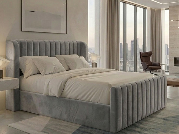 A front-facing view of the Daniela ottoman storage bed frame upholstered in grey smooth velvet, highlighting the fluted headboard and curved wing design.