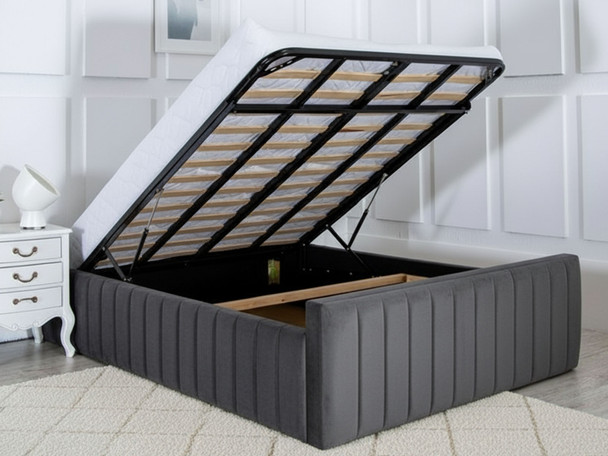 Grey ottoman bed open showing deep under-bed storage with gas-lift mechanism and solid base boards.