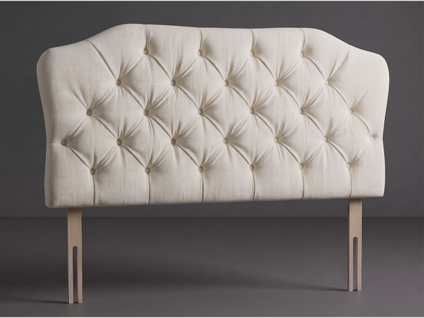 Astoria bed headboard in Ivory Atlanta fabric with a shaped top, deep diamond tufting, matching fabric buttons and wooden fixing struts