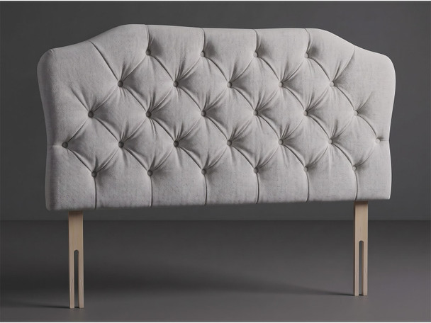 Astoria bed headboard in Silver Atlanta fabric with a shaped top, deep diamond tufting, matching fabric buttons and wooden fixing struts