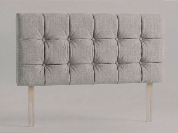 Tessera bed headboard in Silver Atlanta fabric with a grid of padded squares, matching fabric buttons and wooden fixing struts