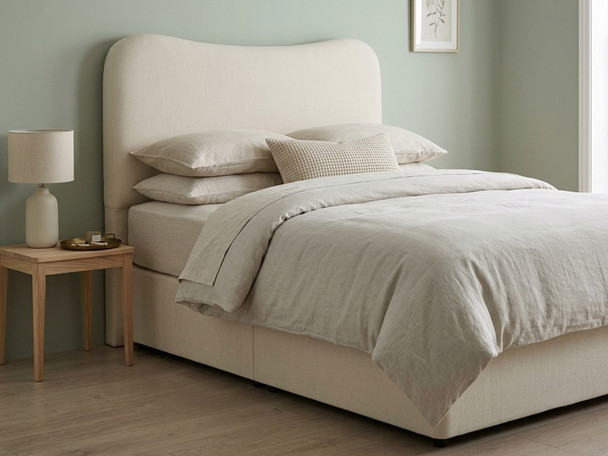 Atlanta Soft Ivory fabric show with a bed: A complete bed frame and headboard fully upholstered in Atlanta soft ivory fabric, styled within a contemporary bedroom setting.