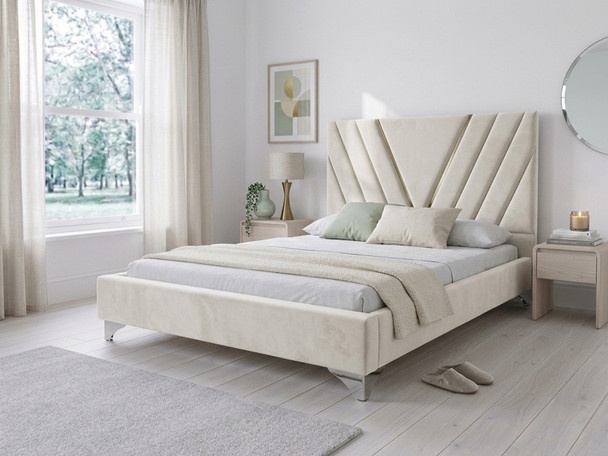 The luxurious Sequoia Upholstered Bed Frame in warm cream velvet fabric, showcasing its modern geometric headboard with a striking V-shaped inlay and cohesive, fully upholstered footboard