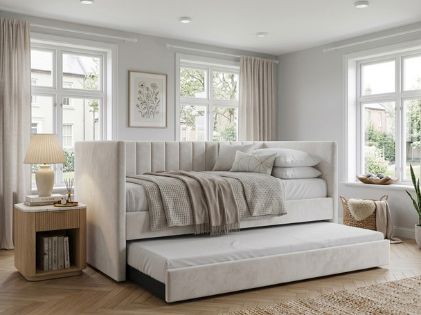Noa Upholstered Daybed in cream velvet, shown with the space-saving pull-out trundle guest drawer extended on castors