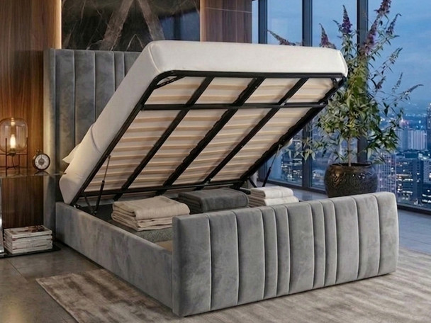 Grey velvet Carla Ottoman Storage Bed with gas-lift mechanism raised, showing the solid base storage area