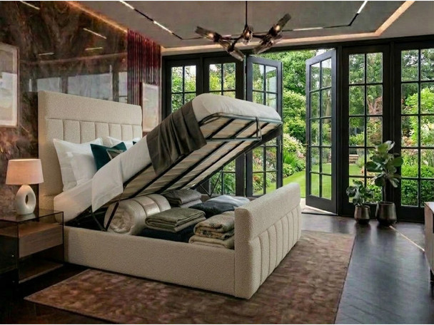 Cream bouclé Maricela ottoman bed open on gas-lift struts, showing the under-bed storage full of bedding