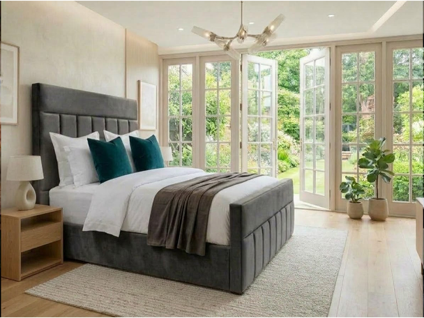 Maricela ottoman storage bed in grey velvet with a tall headboard, vertical channels and a matching channelled footboard, handmade in Birmingham