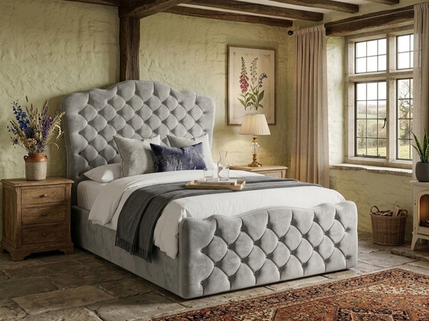 Melibea Ottoman Storage Bed Frame upholstered in plush silver velvet, featuring a tall 145cm camelback headboard with deep diamond-button tufting and a matching footboard