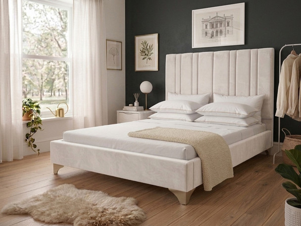 Mirta upholstered bed frame in luxurious cream velvet, showcasing a tall, vertically channeled headboard and a clean, spacious silhouette.