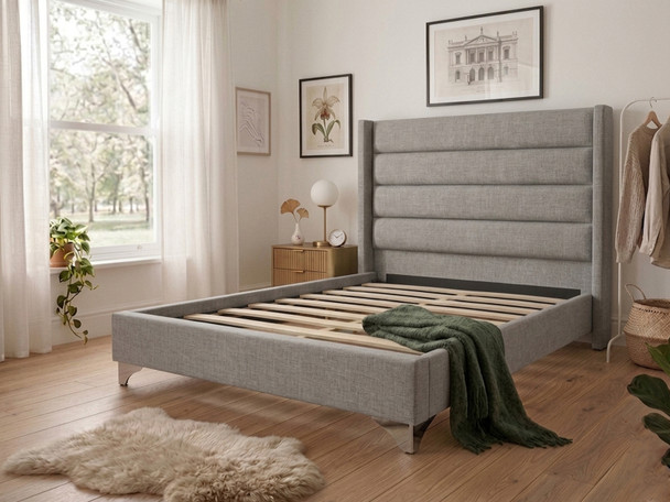 Grey linen Micaela upholstered bed frame shown without a mattress, revealing the heavy-duty solid wooden slats and sturdy centre support bar designed for longevity
