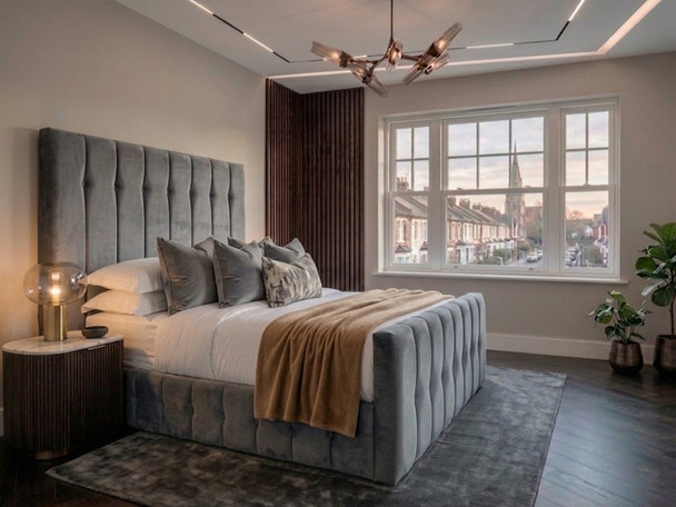 The Tarja Ottoman Storage Bed Frame upholstered in plush grey velvet, featuring a tall headboard with deep architectural fluting and custom tufting