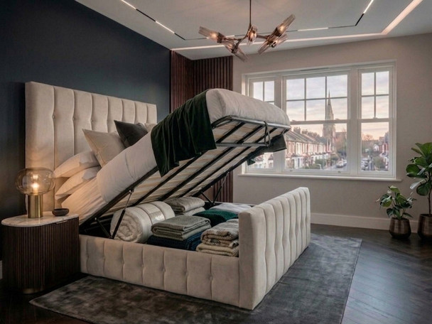 The cream velvet Tarja Ottoman Bed with its steel-reinforced lifting frame fully open, displaying the expansive, floor-clearing under-bed storage compartment