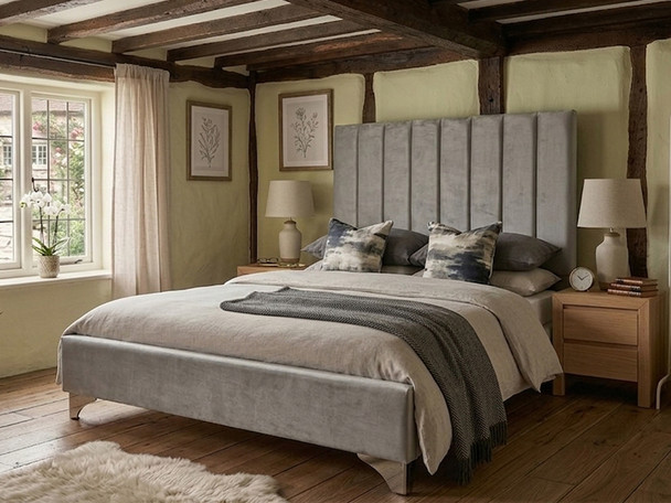 Zofia upholstered bed frame in smooth grey velvet fabric, featuring a tall vertical fluted headboard and a modern low footboard.