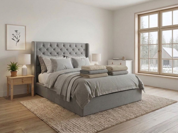 Modern upholstered ottoman bed frame finished in luxurious silver smooth velvet fabric, with headboard and footboard in the closed position.