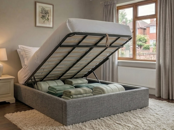 Lena ottoman bed base in grey steel fabric with the gas-lift lid open, showing the storage area with ample capacity for bedding and towels