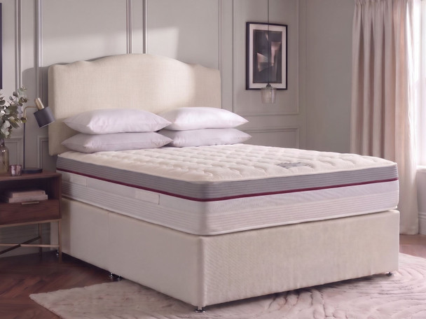 Side view of the Sorielle divan bed with Ashbury Crown Top headboard, showing the mattress grey border and burgundy piping