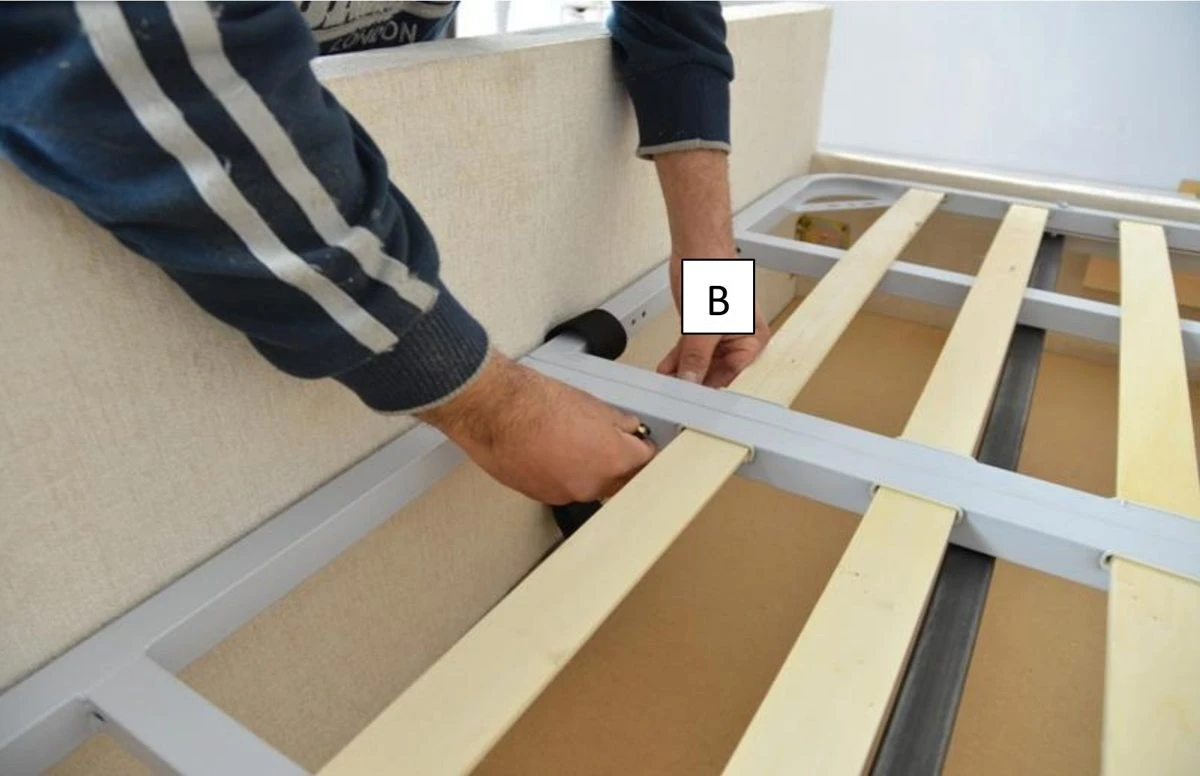Fitting bolt B through the centre of the ottoman slatted frame