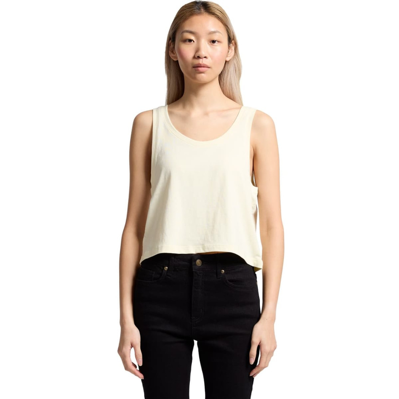 A cropped singlet in pale yellow worn with black pants, featuring a simple design and a small logo.