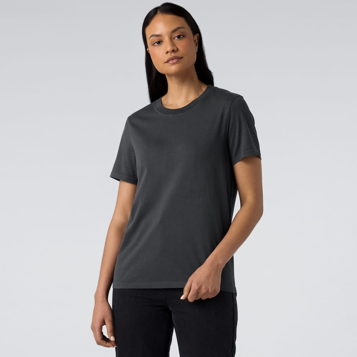 A women's dark grey t-shirt with a classic fit and a logo on the front, displayed against a light background.