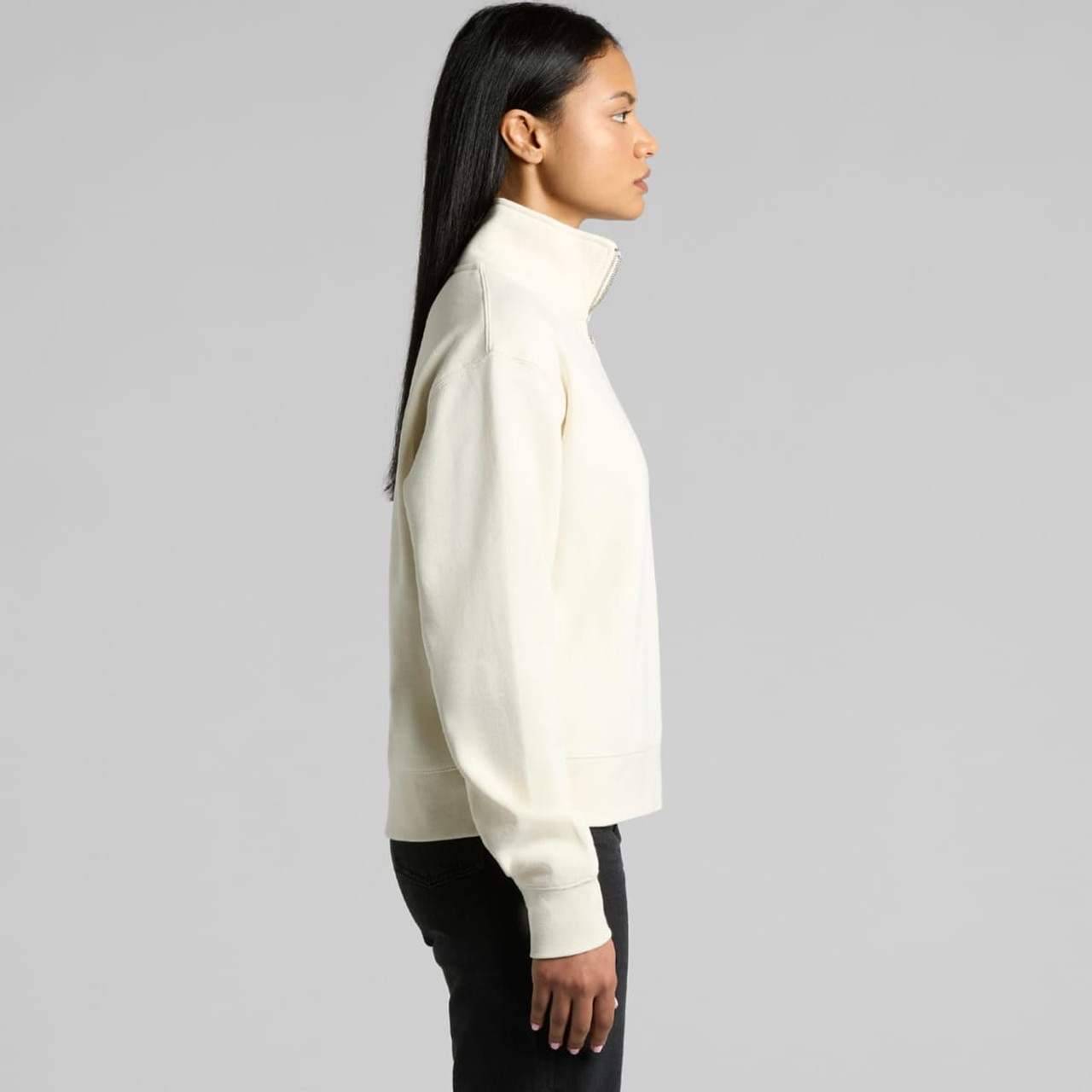A cream-coloured half zip crew jumper with a relaxed fit and a logo on the side.