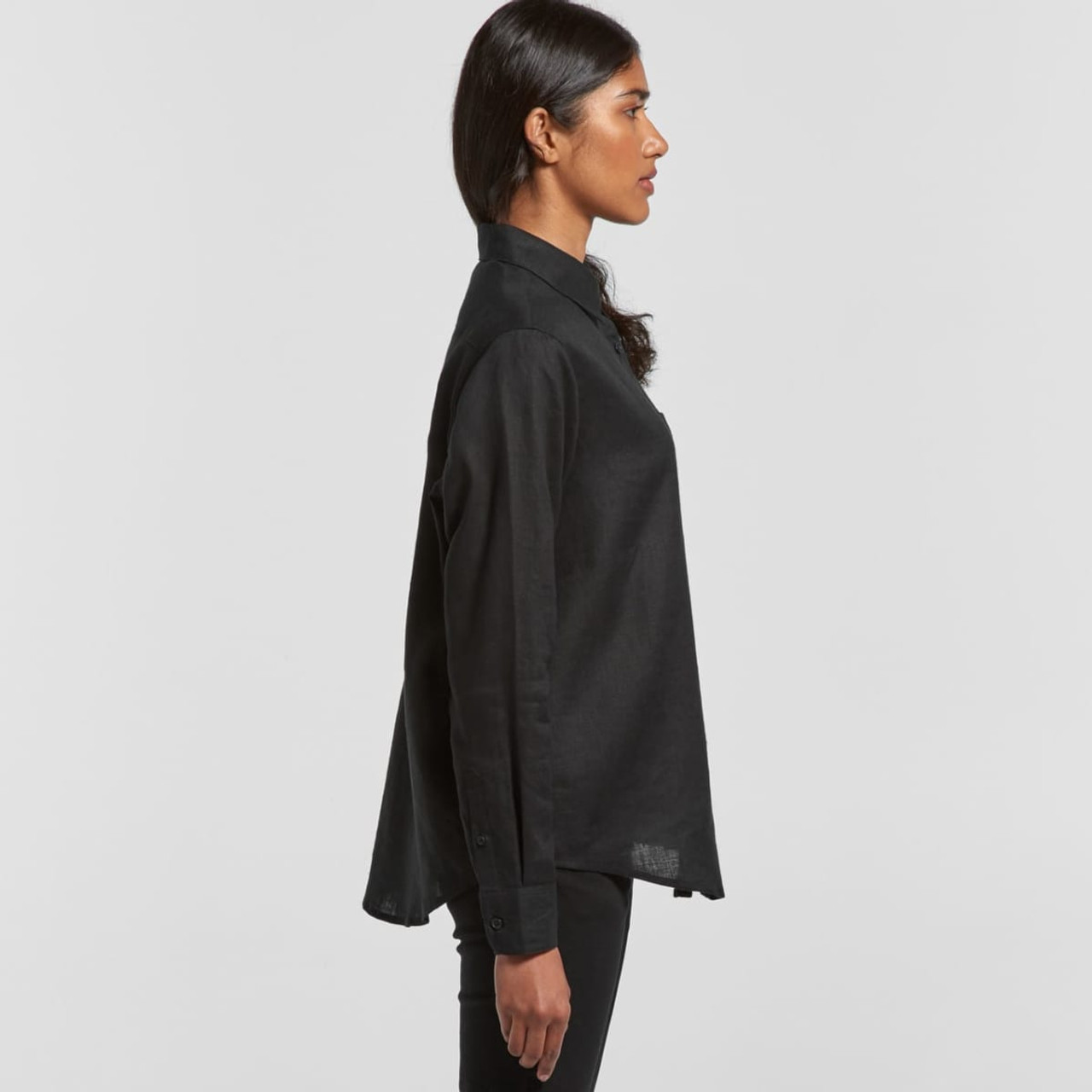 A black linen button-up shirt displayed on a model from a side view, featuring a collar and long sleeves.