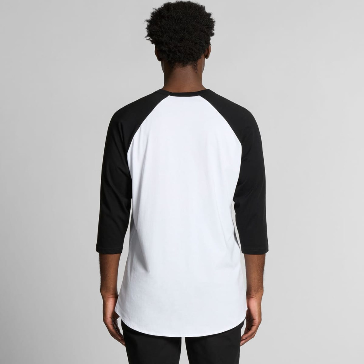 A raglan tee with a white body and black three-quarter sleeves, featuring a logo on the back.