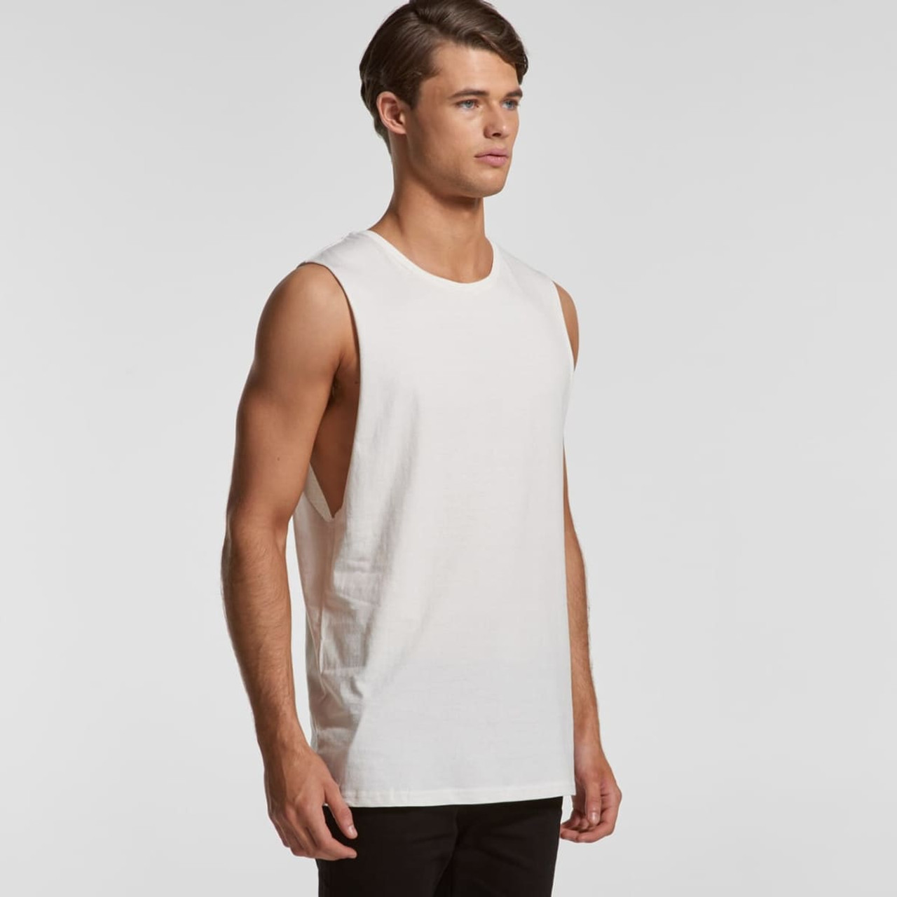 A sleeveless organic tank top in off-white, featuring a relaxed fit and a branding logo.