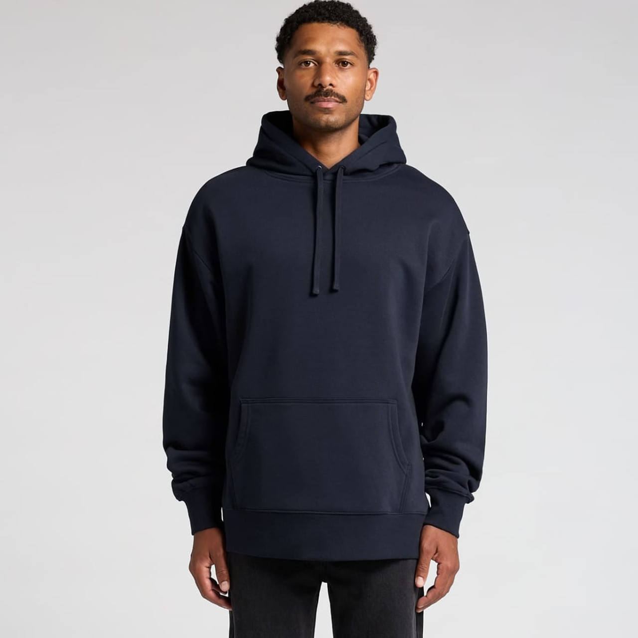 A navy hoodie with a front pocket and drawstrings at the hood, modelled by a man. The hoodie features a logo.