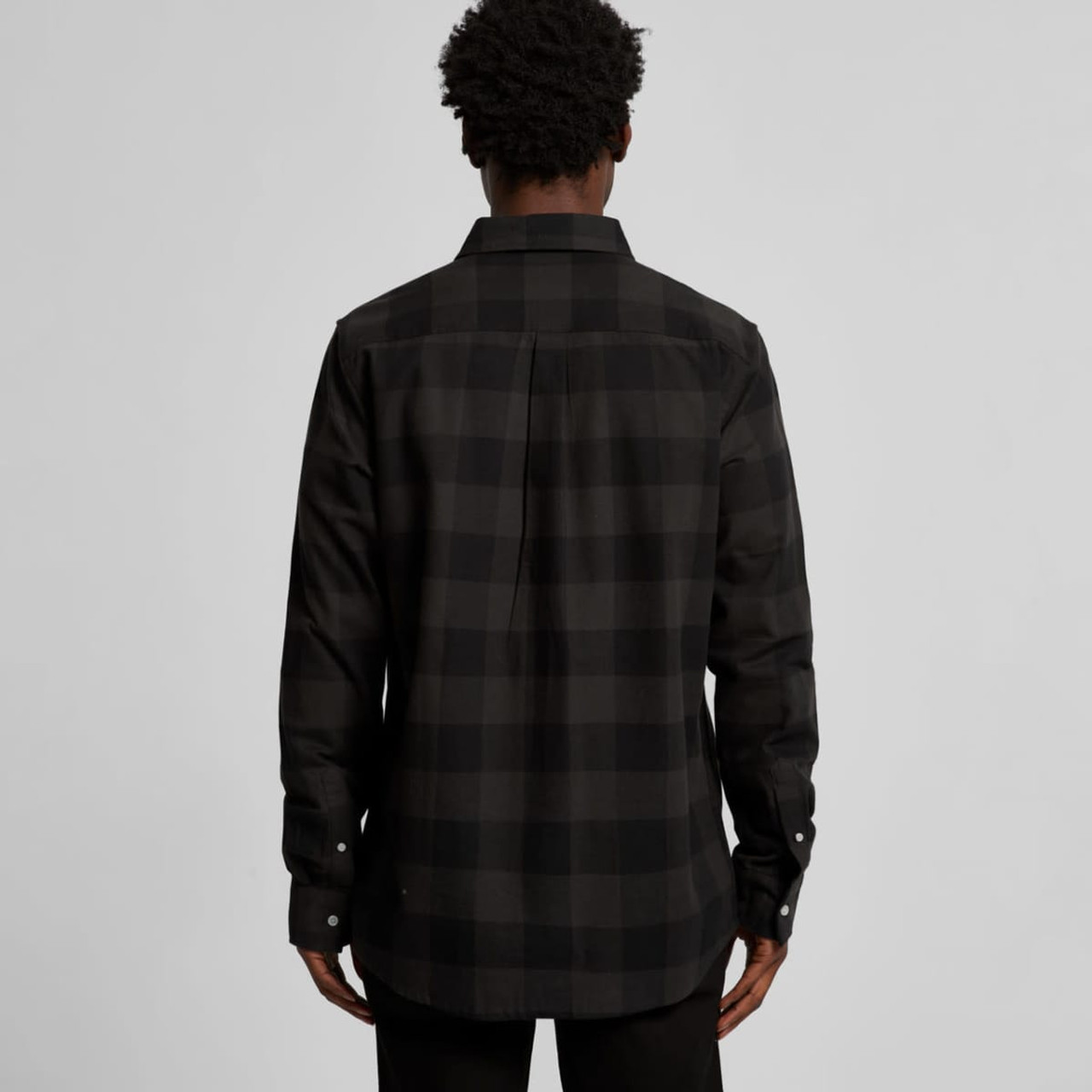 A black check button-up shirt with a solid back and long sleeves. The shirt features a classic collar and a logo.