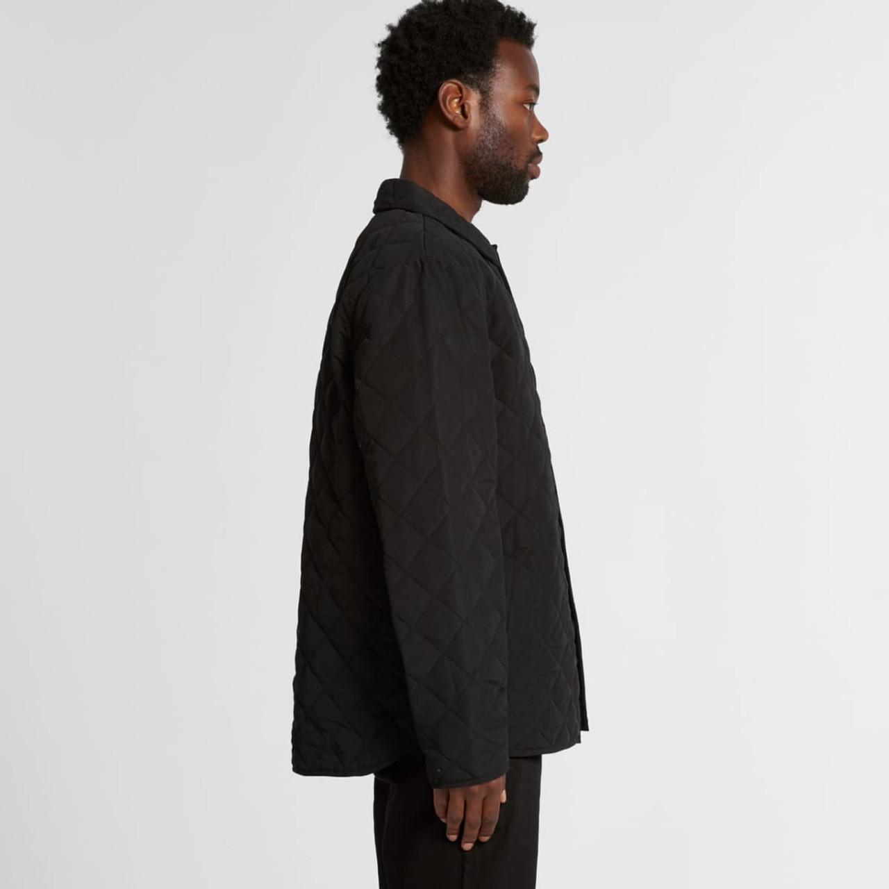 A black quilted puffer jacket viewed from the side, featuring a button-down front and a subtle logo.
