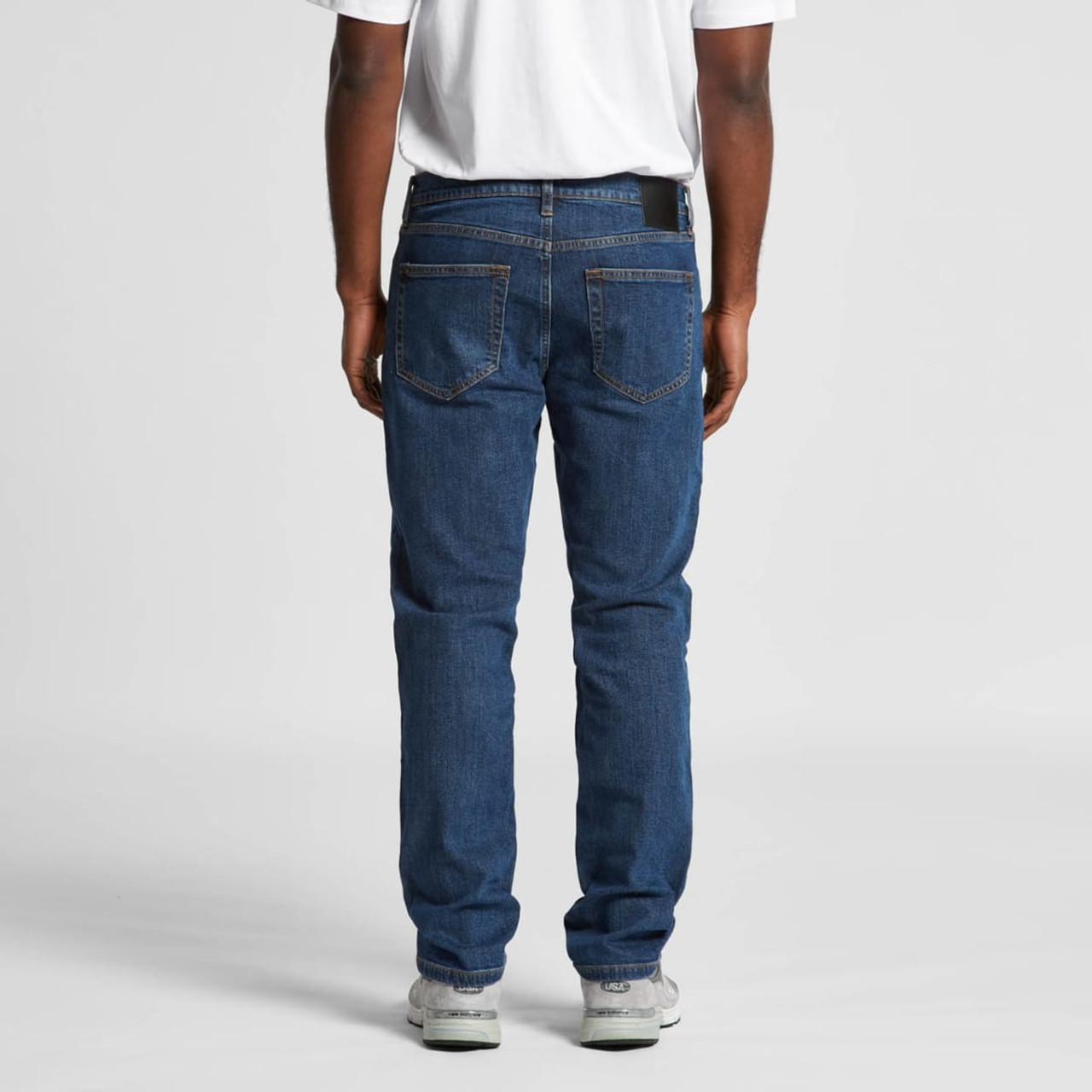 A pair of blue standard jeans, featuring a classic five-pocket design, viewed from the back.