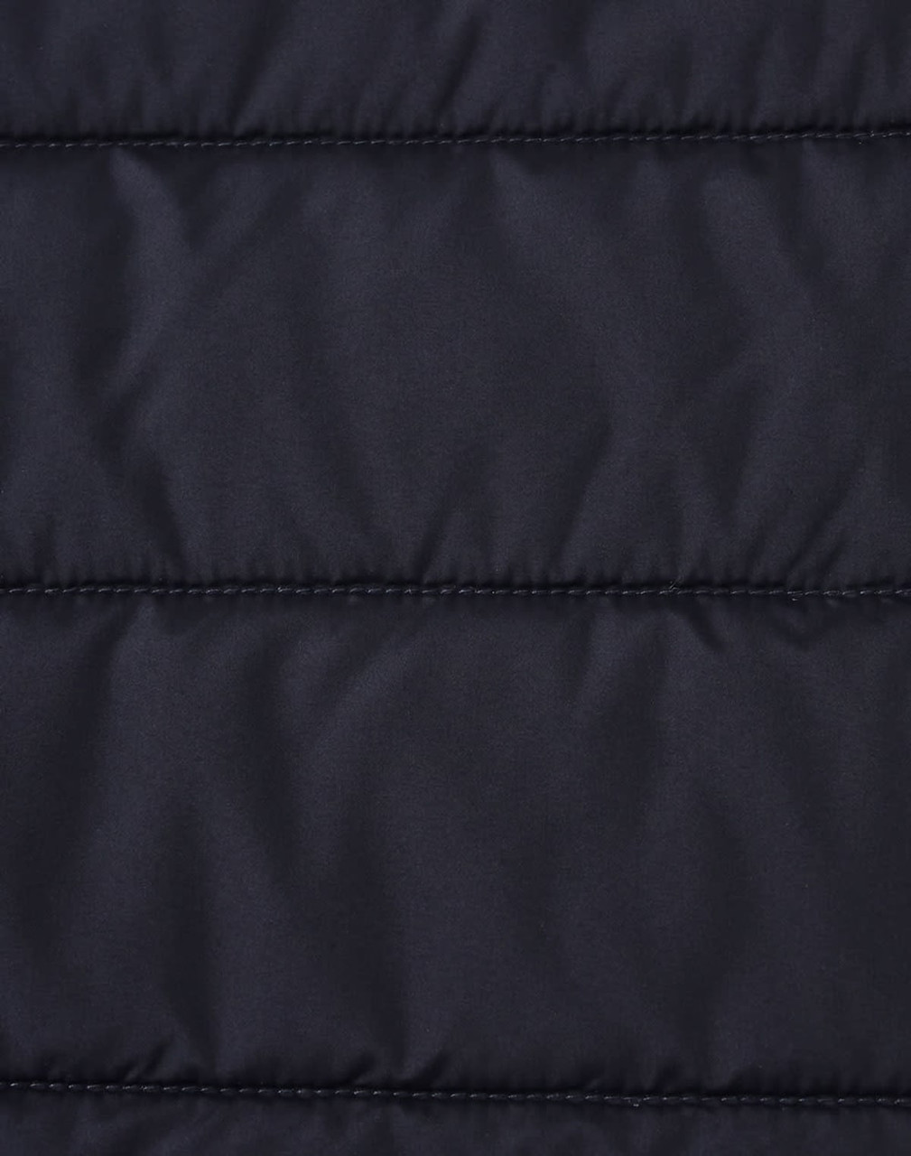 A close-up of a navy blue insulated puffer jacket fabric with a stitched, quilted pattern and a logo.