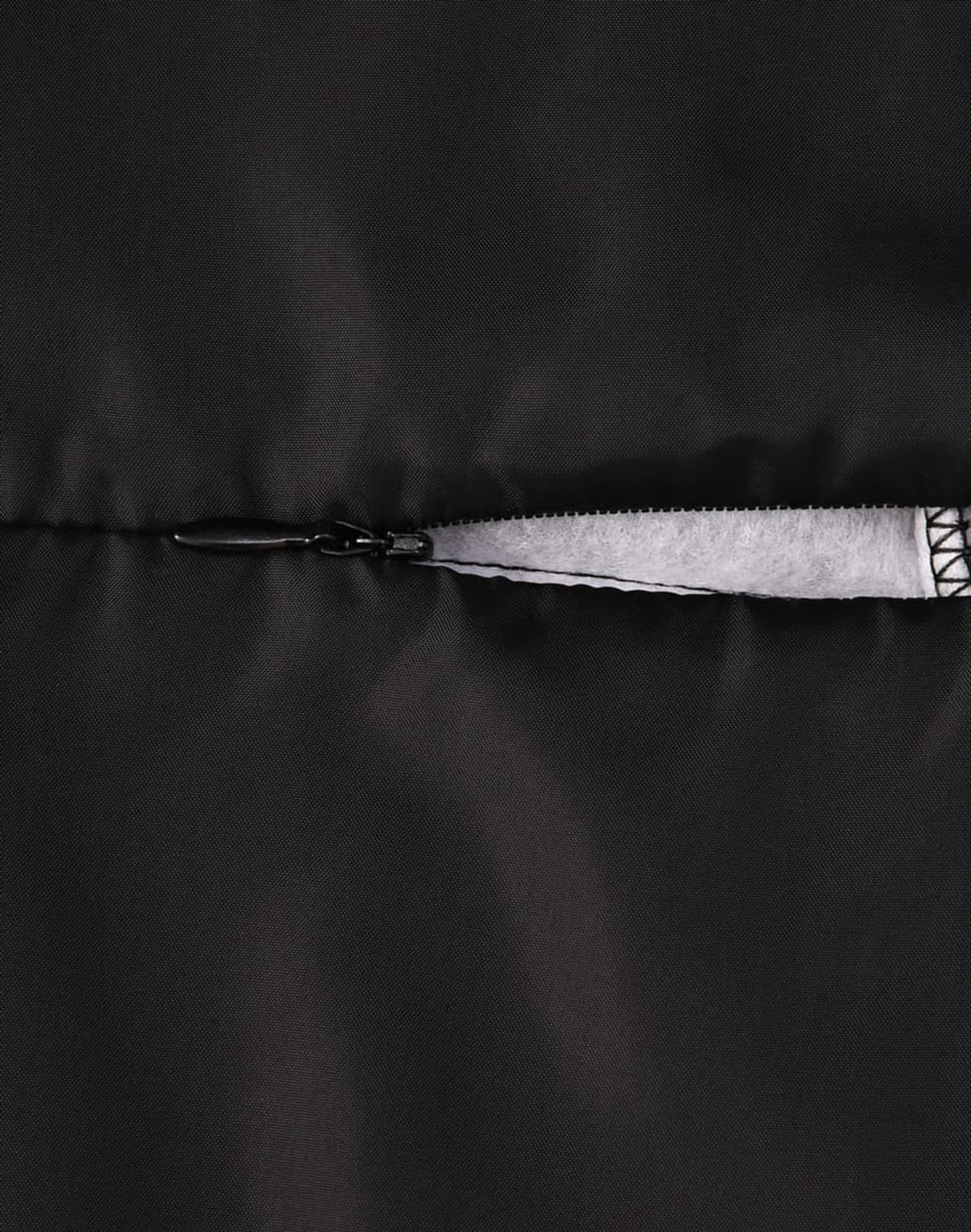 A close-up of a black insulated puffer jacket zipper, featuring a smooth, sleek design with contrast detailing.