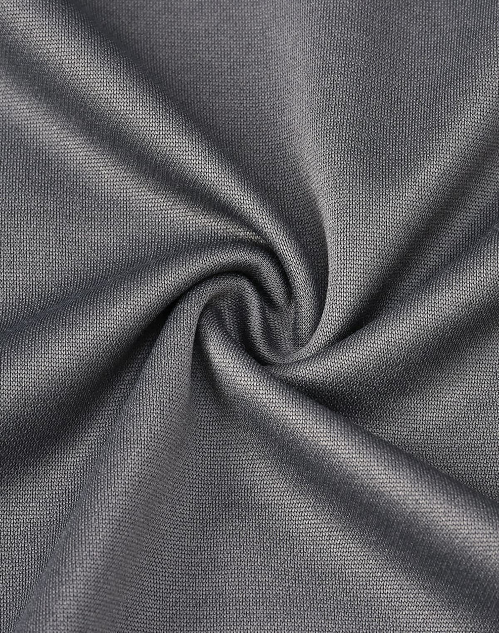 A close-up view of grey fabric, showcasing a smooth texture with a subtle sheen and a twisted pattern.