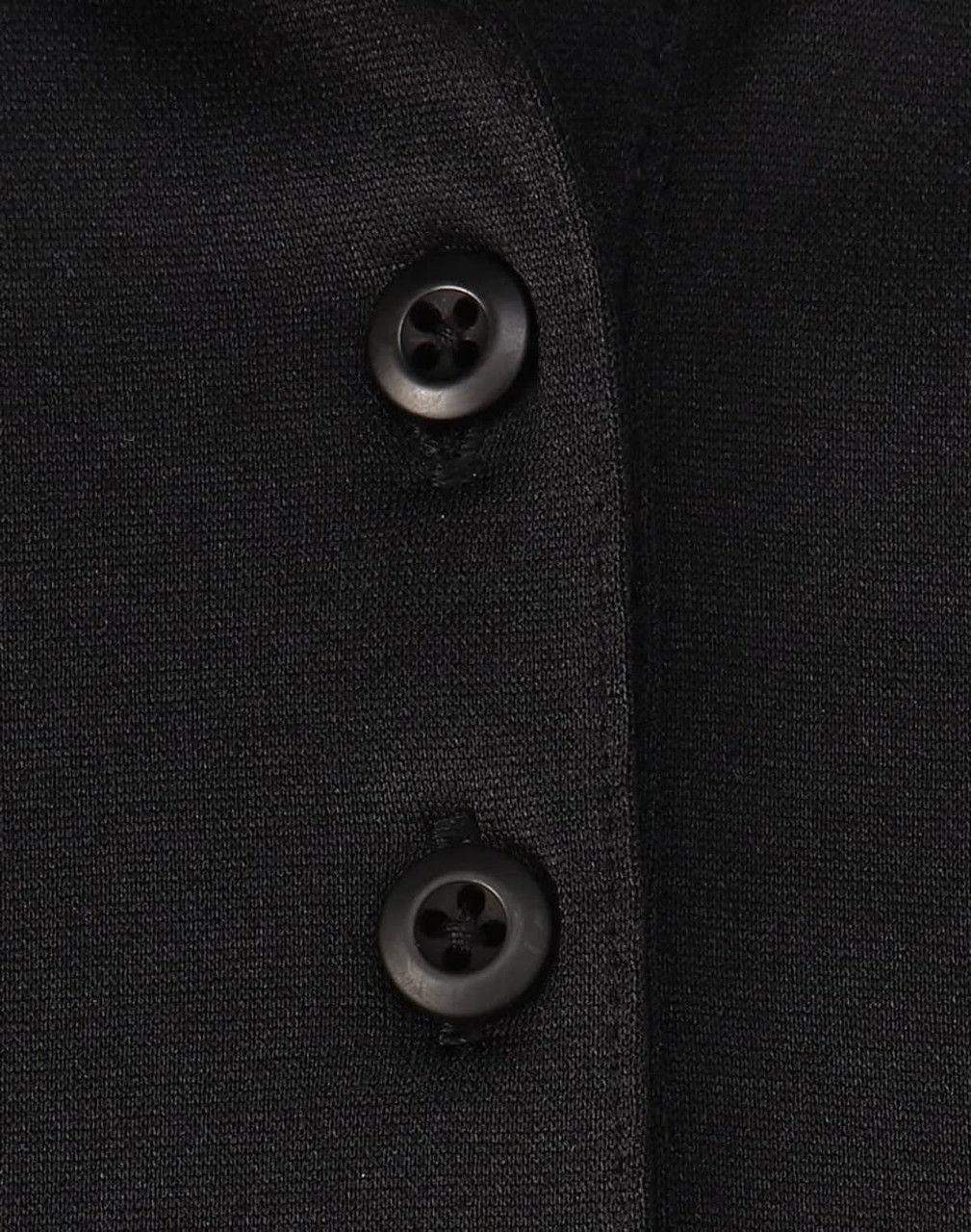 A close-up of a black polo shirt featuring buttons and a subtle texture, highlighting its sustainable fabric.