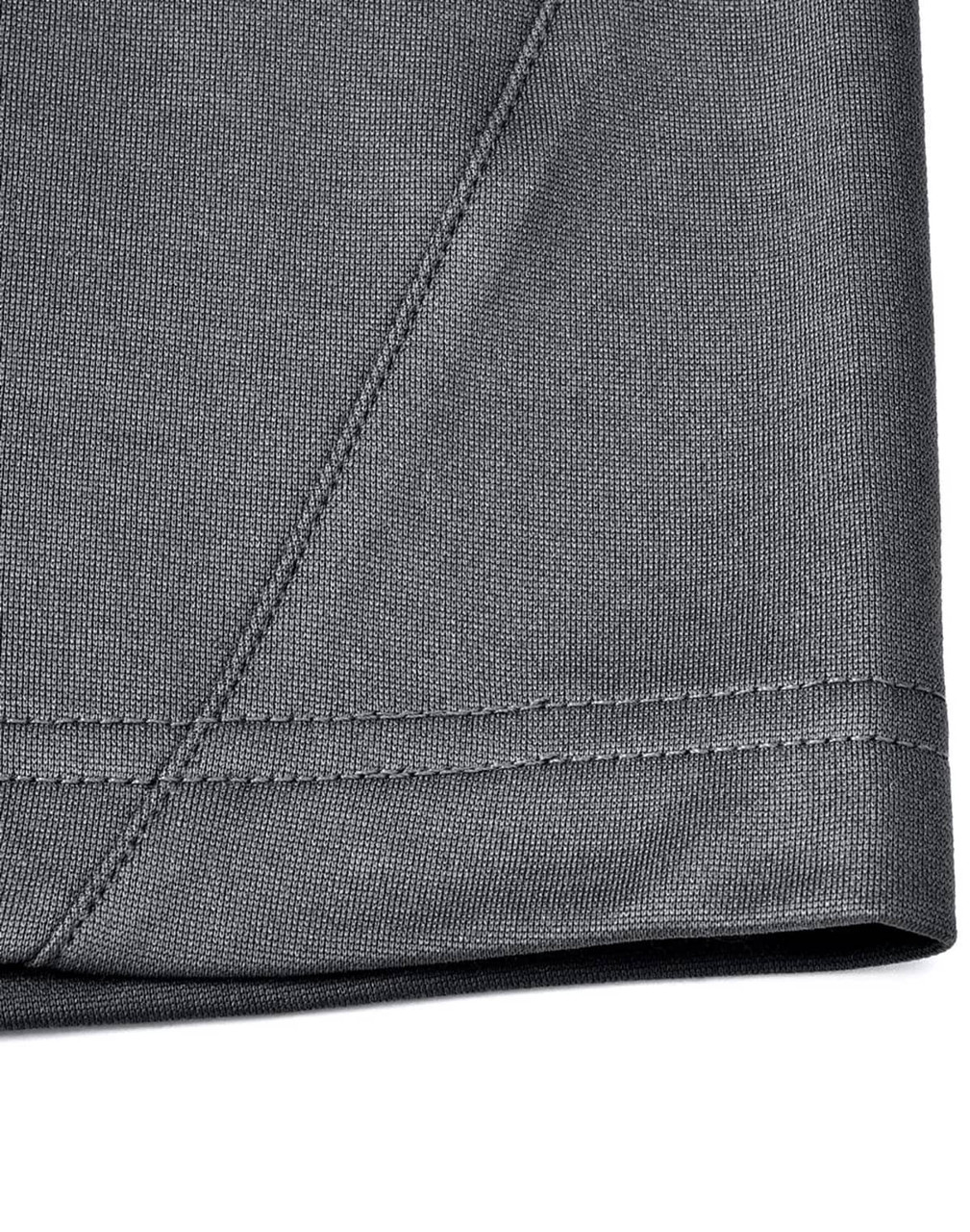 A close-up of the hem and stitching of a grey polo shirt made from sustainable poly/cotton fabric.