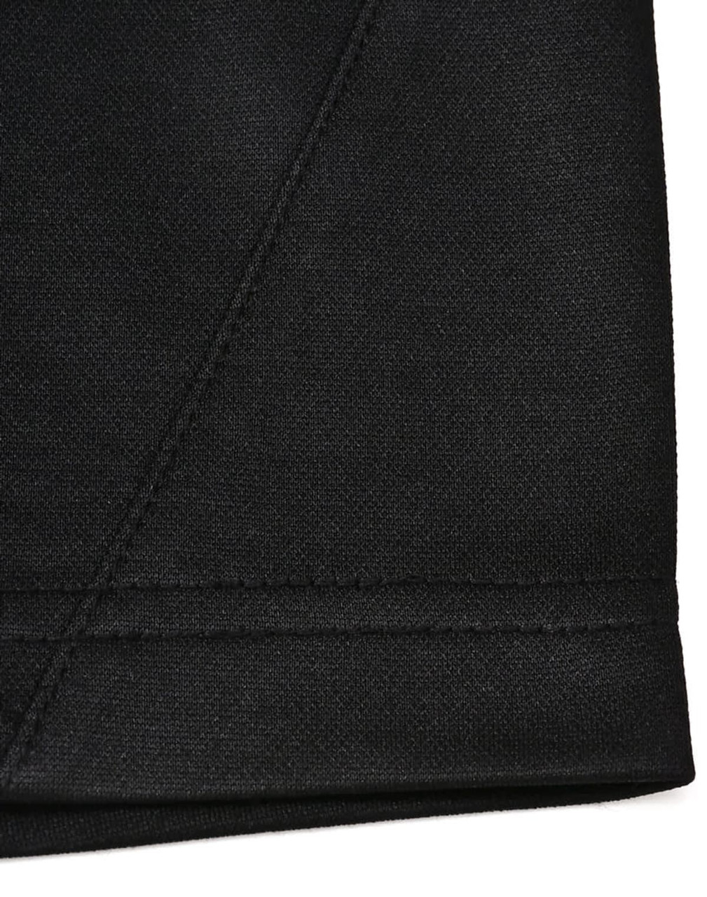 A close-up of a black sustainable poly/cotton polo shirt showing the hem and stitching details. Features a logo.