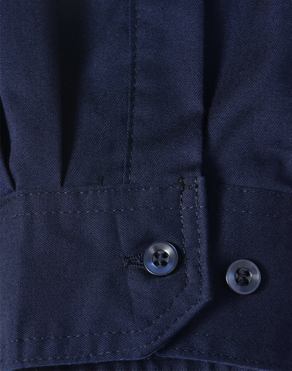 A close-up of a blue long-sleeve shirt featuring segmented tape, with a buttoned cuff detail.