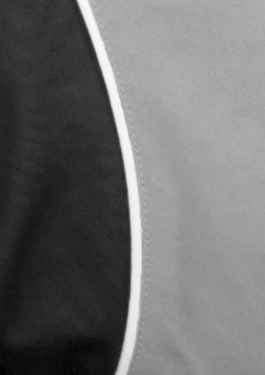 A black and grey short sleeve shirt featuring a curved design and contrast piping, with a logo displayed.