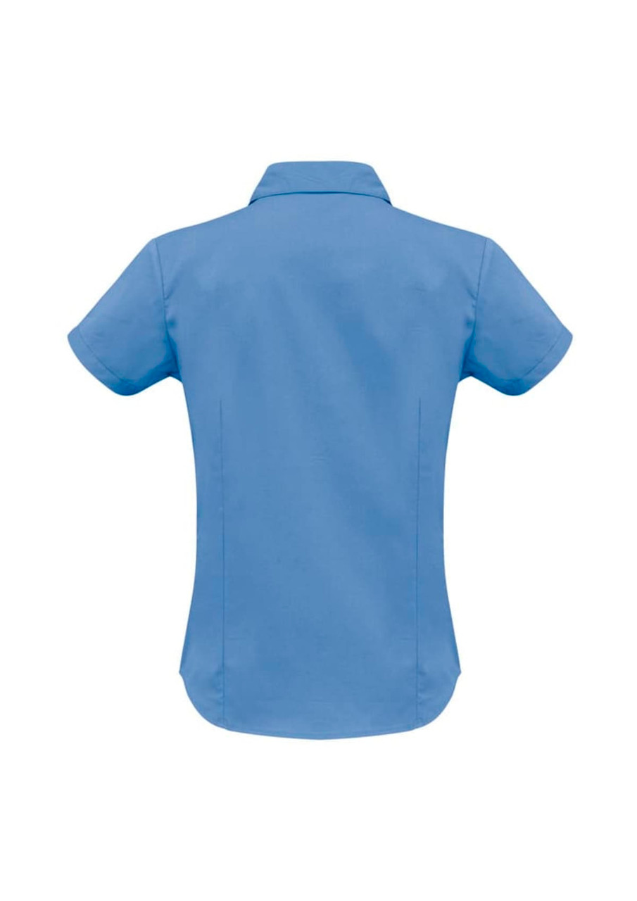 A women's short sleeve shirt in light blue with a curved hem and a collar, featuring a logo.
