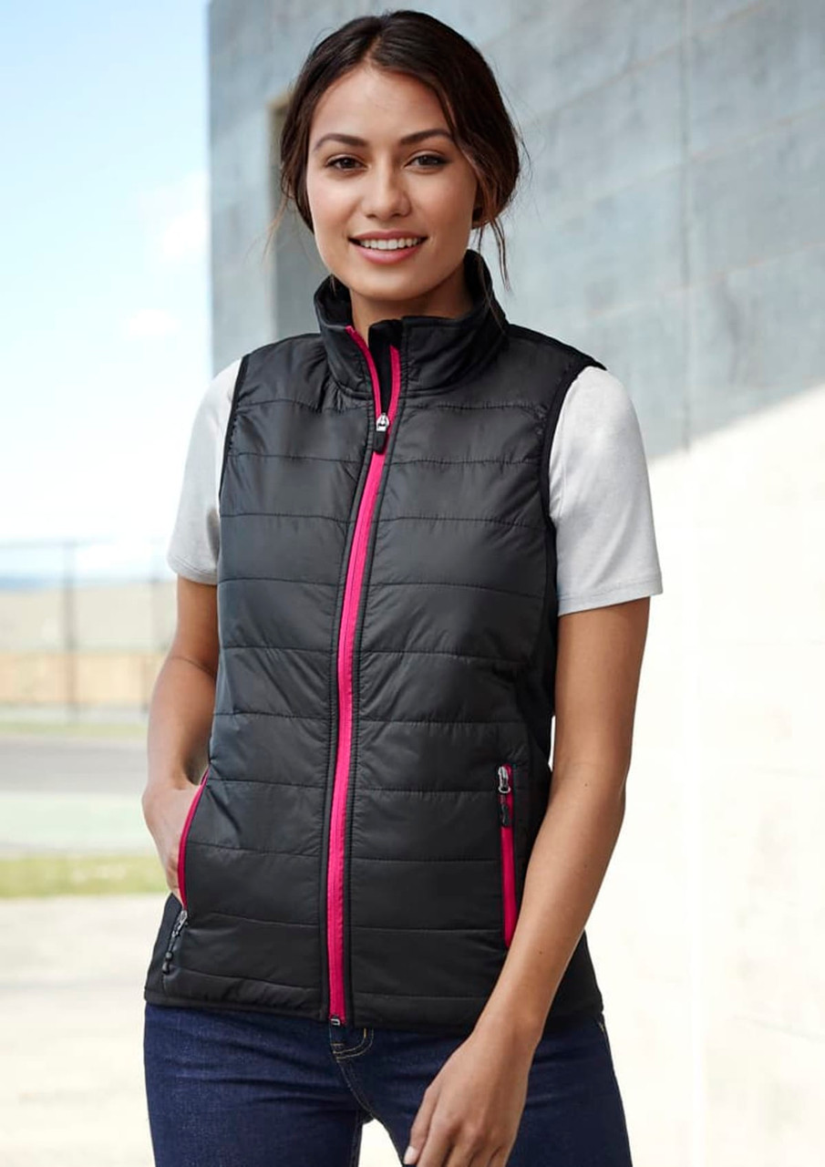 A black women's vest with pink zippers and pockets, featuring a quilted design and a high collar.