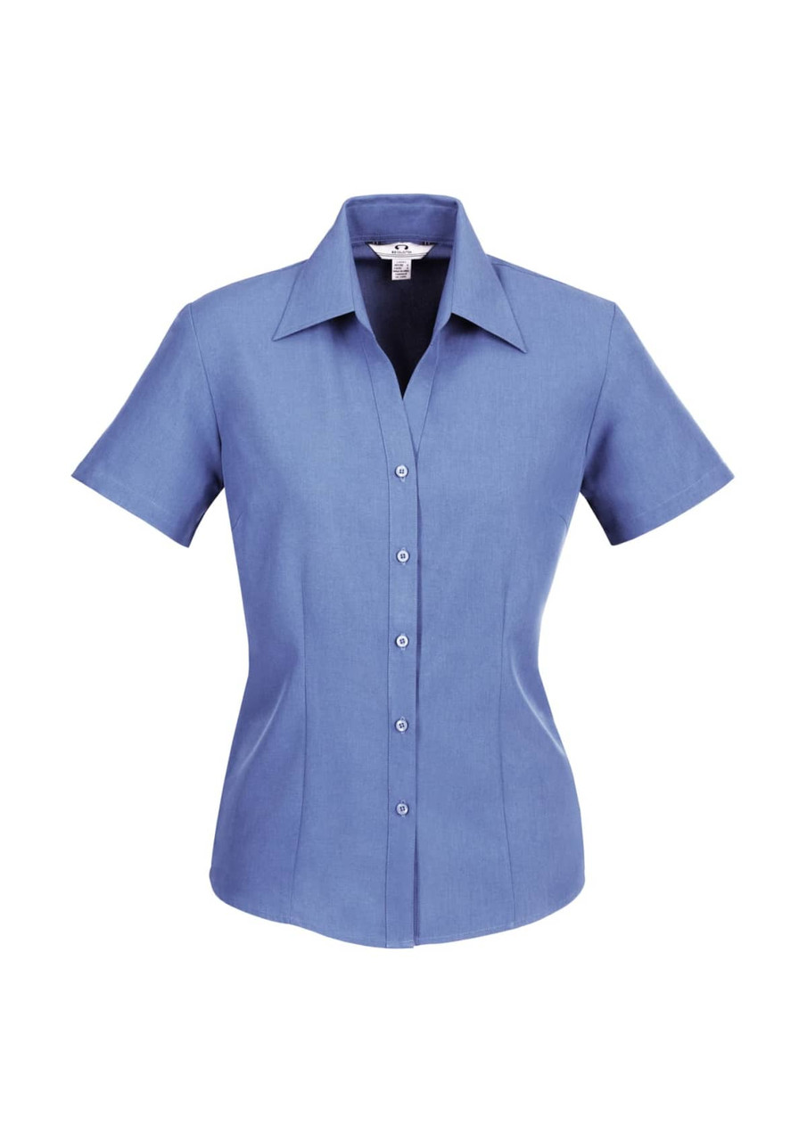 A blue women's short sleeve button-up shirt with a pointed collar and a fitted silhouette, featuring a logo.