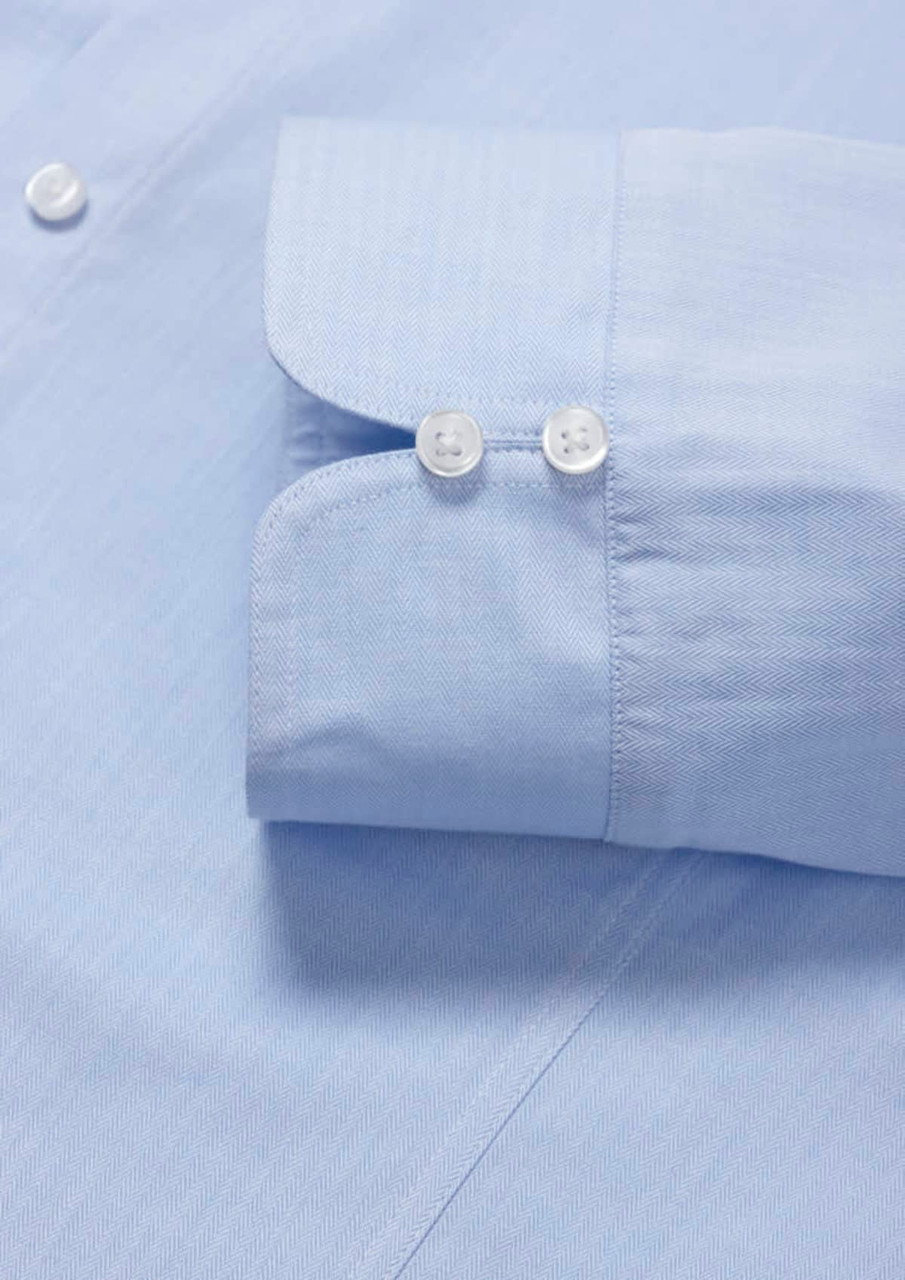 A light blue women's luxe long sleeve button-up shirt featuring a double cuff design and buttons.
