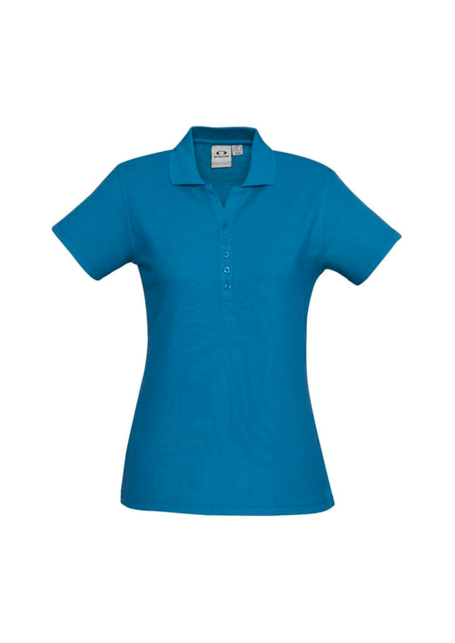 A blue ladies polo shirt featuring a collar and button placket, with a logo on the fabric.